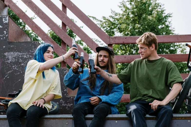 three friends sitting on a bench taking a selfie