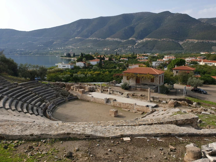 this is an old roman amphit with some grass and trees around it