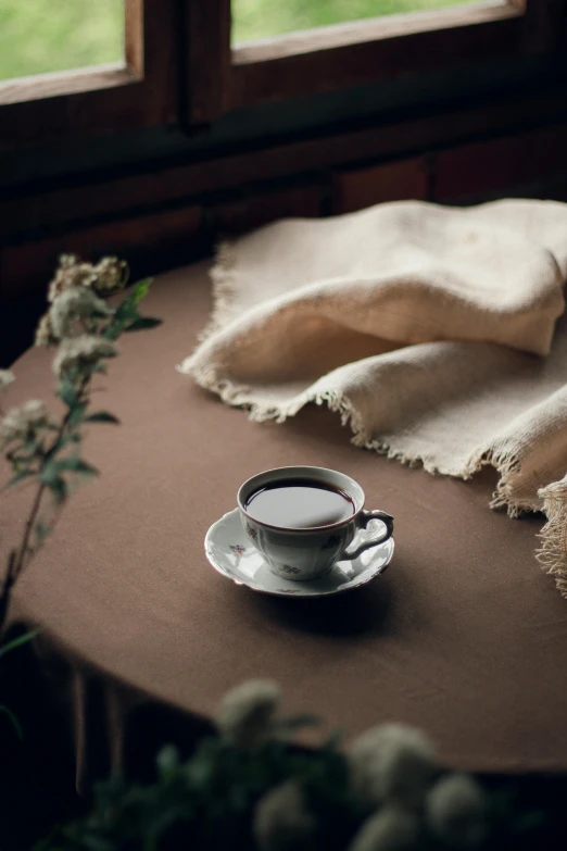 a tea cup sitting on top of a brown table