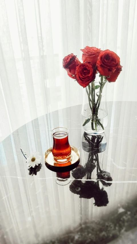 a table with flowers and a teacup on it