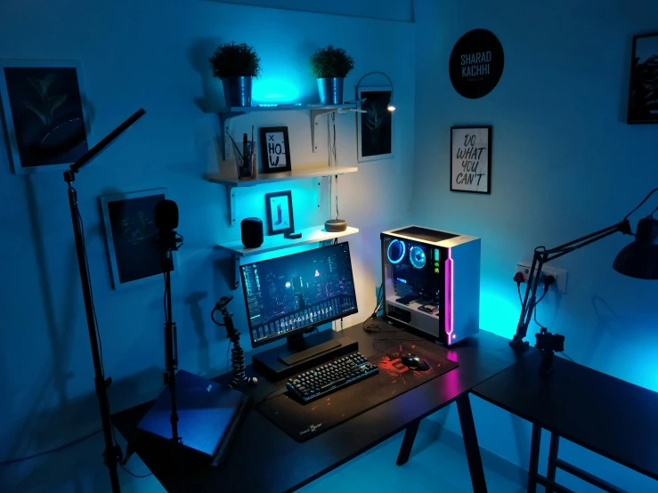 a desk with a computer and monitor sitting on top of it