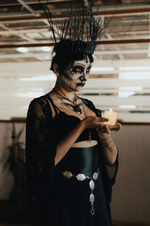 a woman in makeup with candle