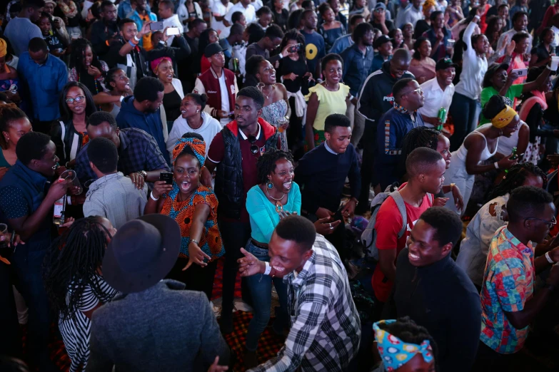 group of people with various cell phones and cameras on their laps