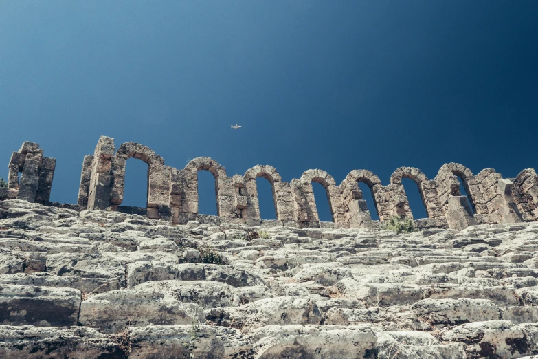 a bird flies low over the wall and sky