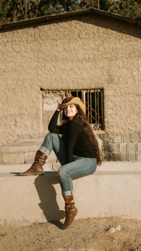 the woman is sitting on a stone step, with her legs crossed