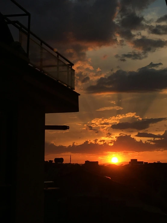 the sun is setting over a cityscape