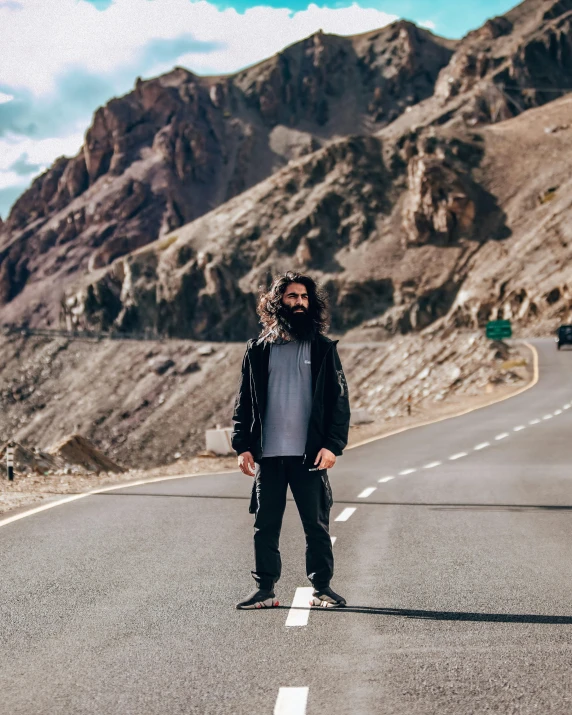 man standing on a highway posing for a picture