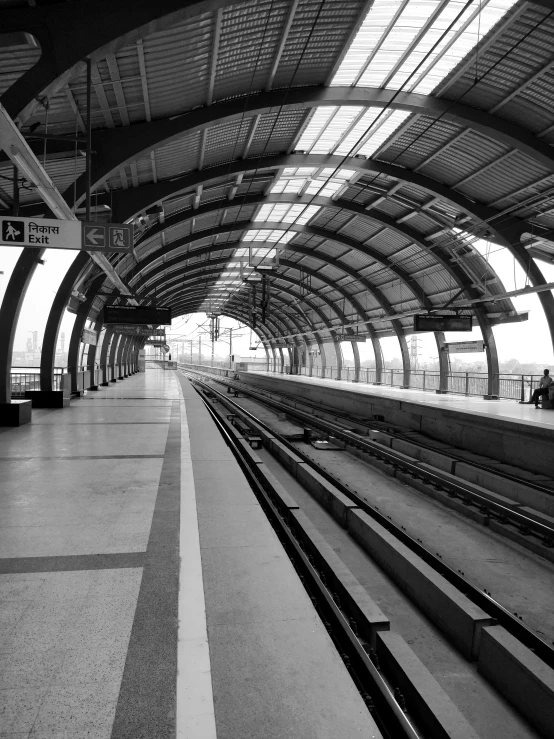 a black and white po of the inside of a train station