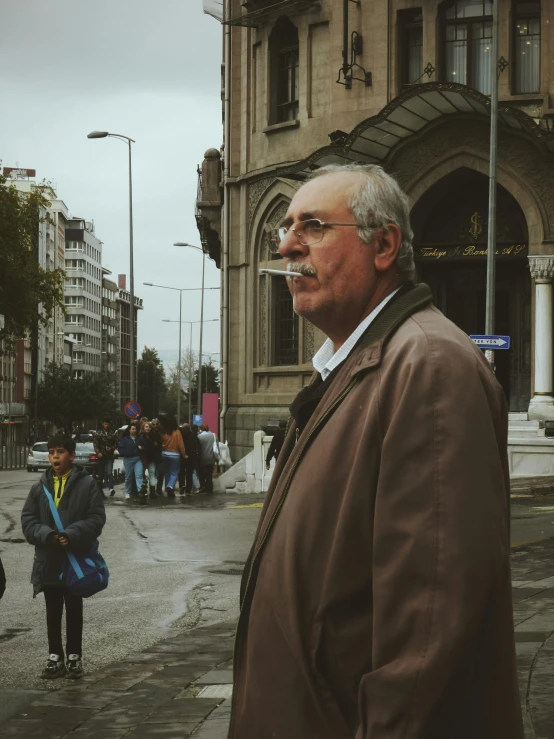 a man is standing on the sidewalk of a city street