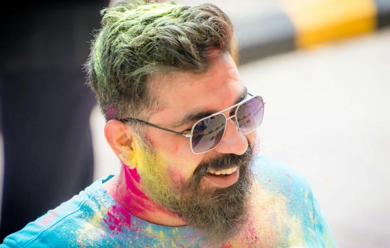 a man with dyed hair and sunglasses walking