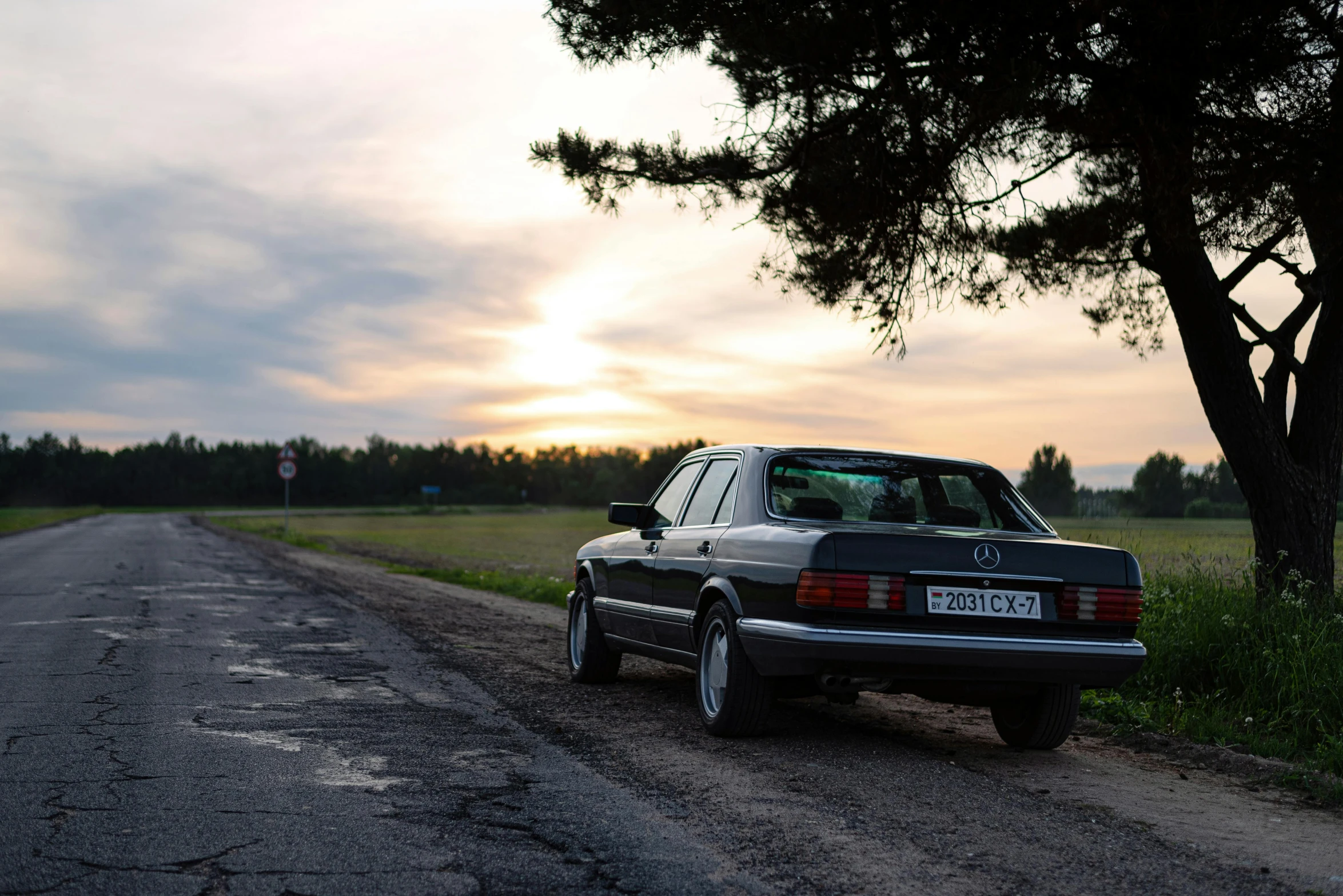 a vintage car parked on the side of the road