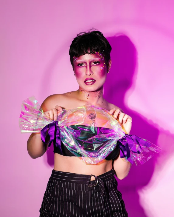 a woman in a purple shirt holding up a plastic model