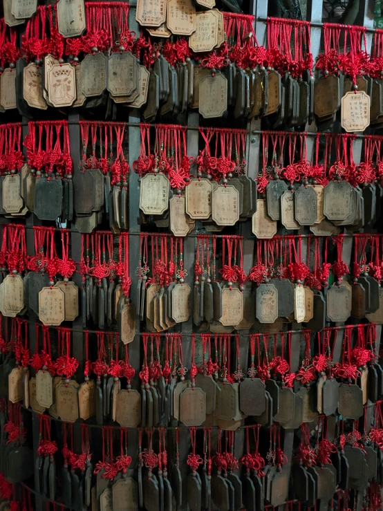 a wall made up of many red and black pieces of luggage