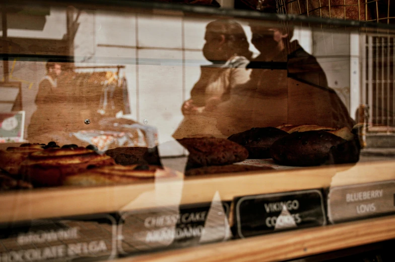 several pastries are sitting on the counter in the front window