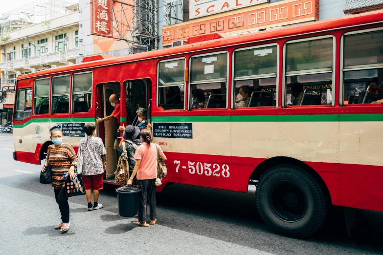 a group of people getting onto a bus