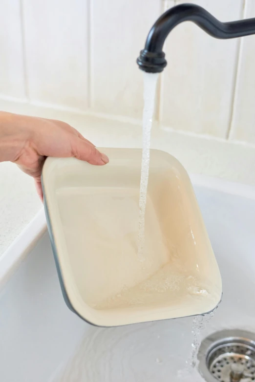 someone washing their hands in the sink with soap