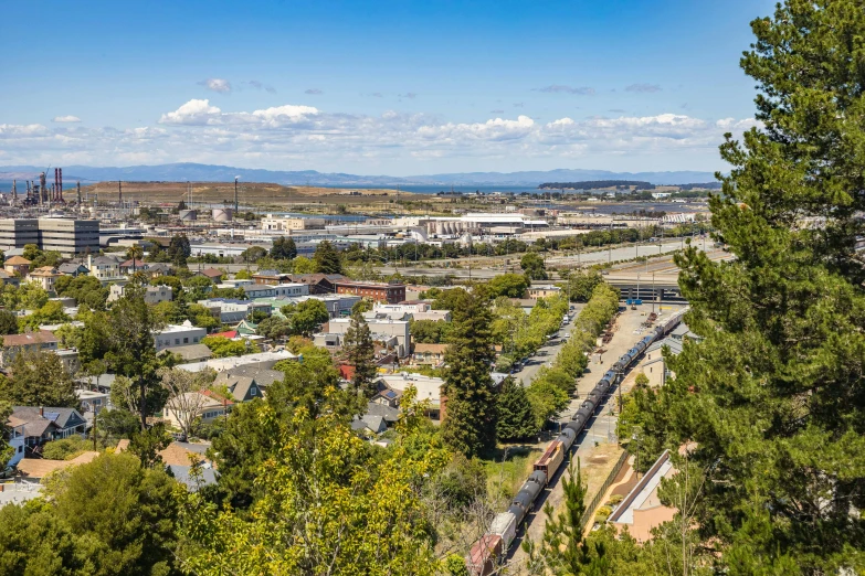 a railroad train going down the tracks in a scenic city