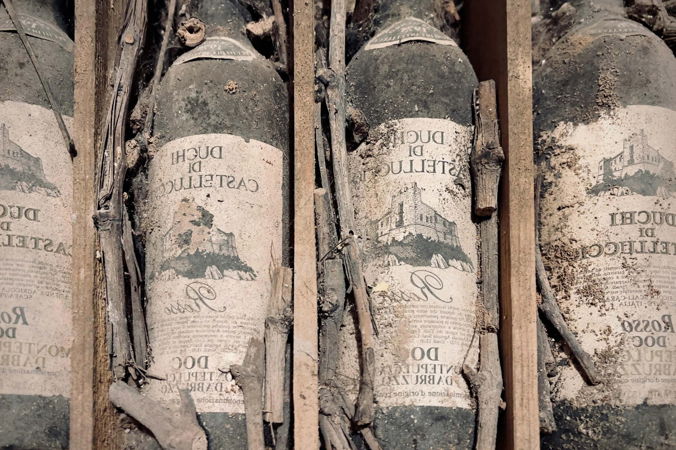 four bottles are in a crate that have been left out