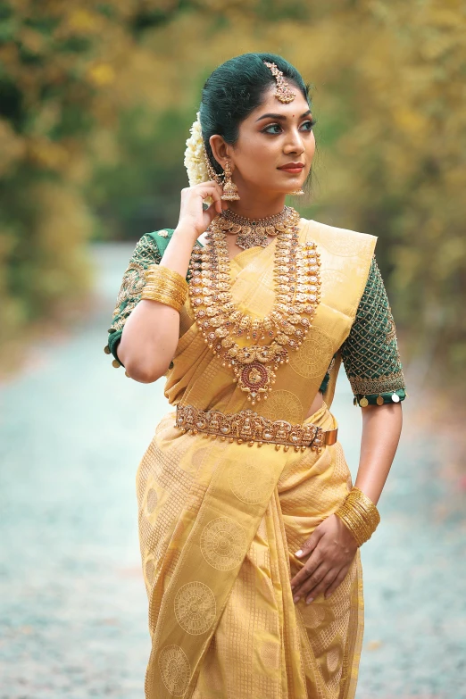 a woman in an orange dress with a very elaborate necklace