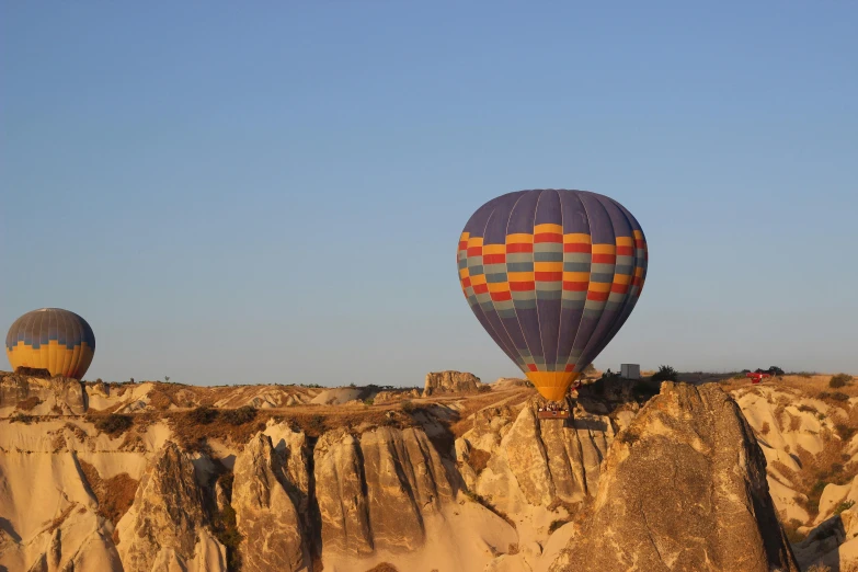 two large  air balloons flying in the sky