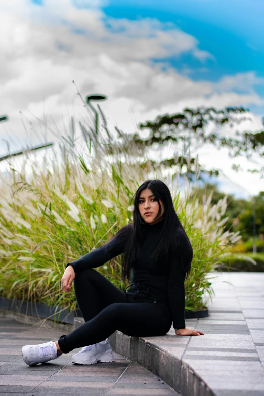 a beautiful woman sitting on top of a concrete step