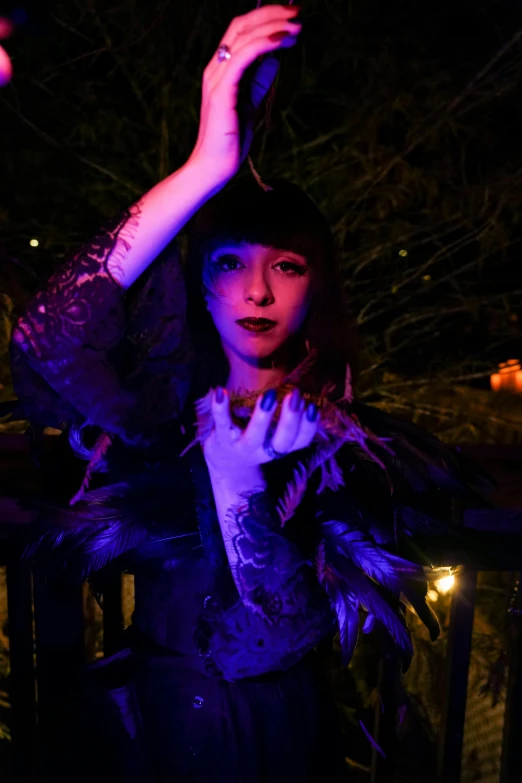 a woman with a feather shawl on posing for the camera