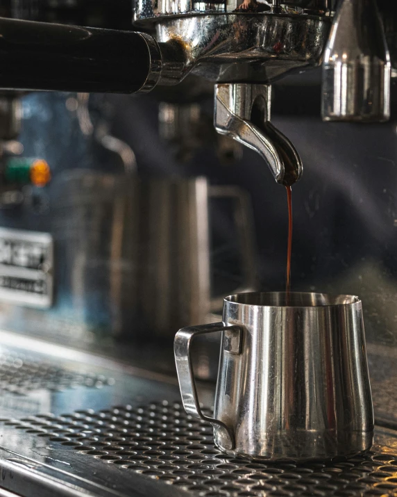 a silver coffee pot pouring coffee from it