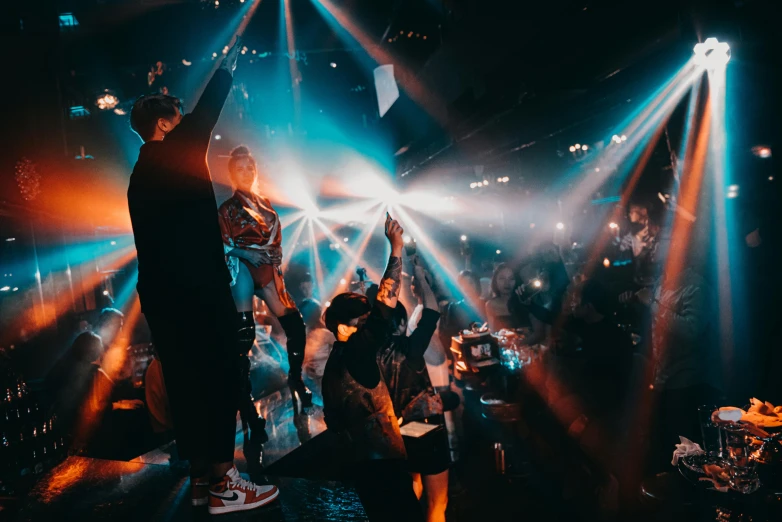 people are standing in front of bright colored beams