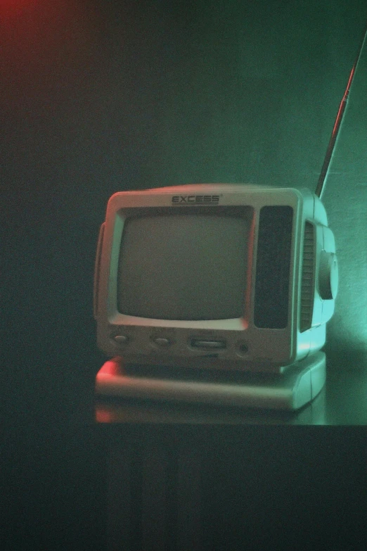 an old fashioned tv in the dark with its antenna exposed