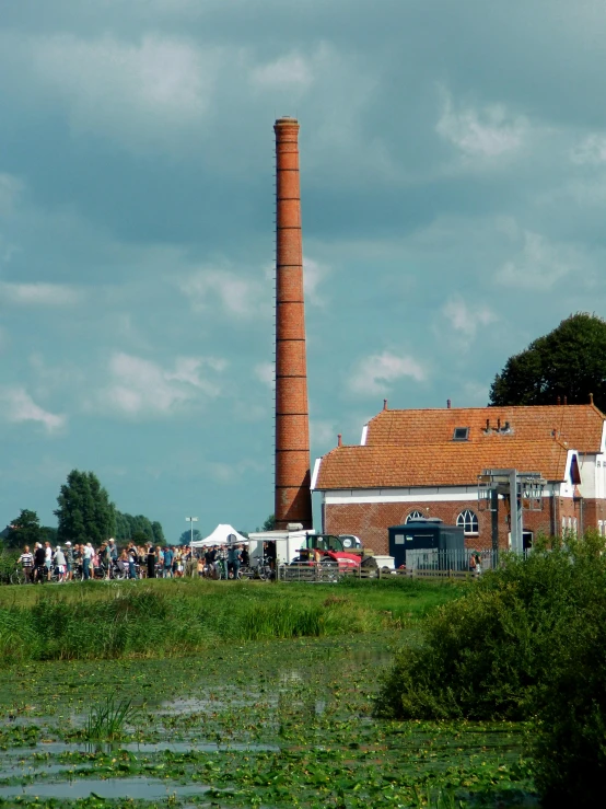 a factory with a large brown tower is shown