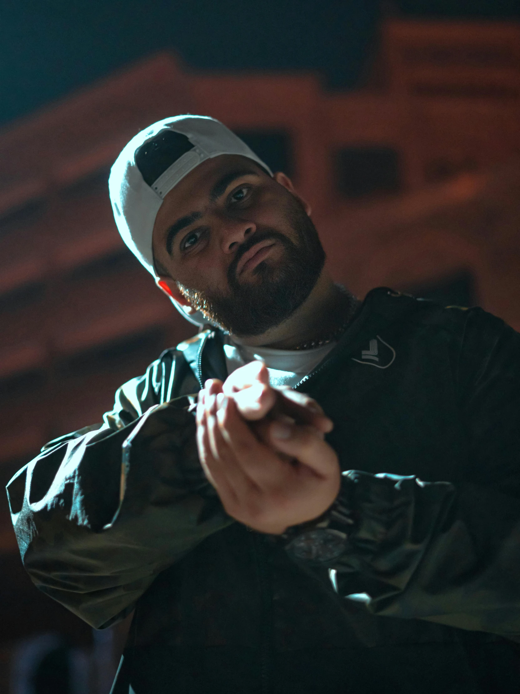 a bearded man wearing a hat and holding a baseball bat