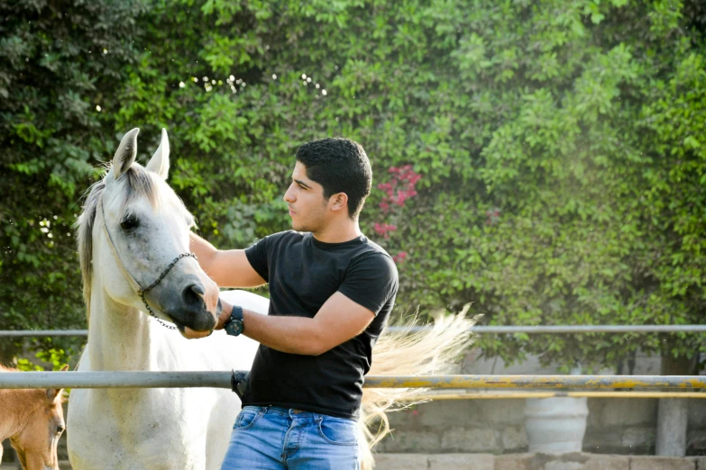 there is a man that is petting a horse