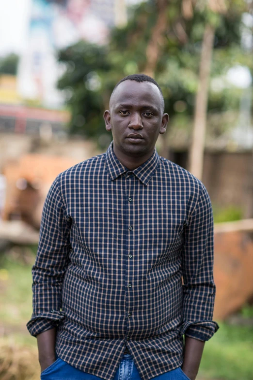 a black man standing with his hands in the pockets