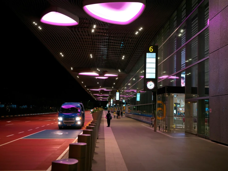 a bus parked in a bus station with lights