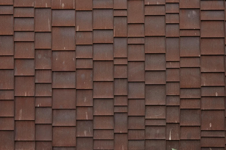 the front of an old red brick wall with a green door