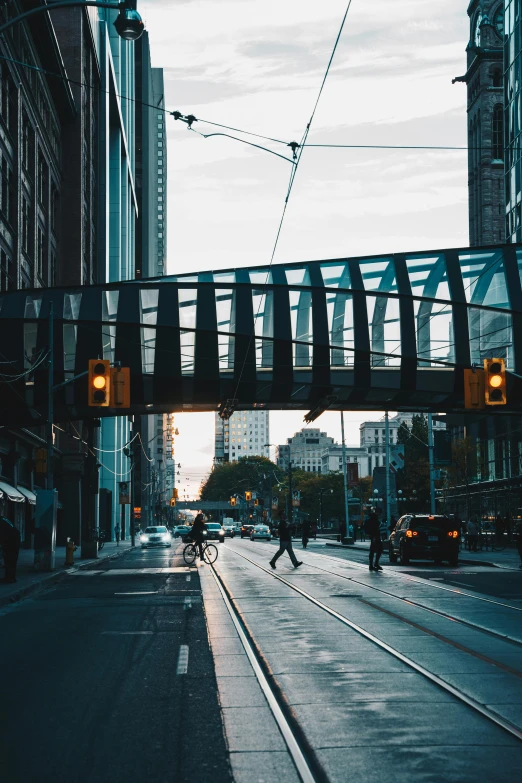 the streetlight is hanging low above the pedestrian tracks