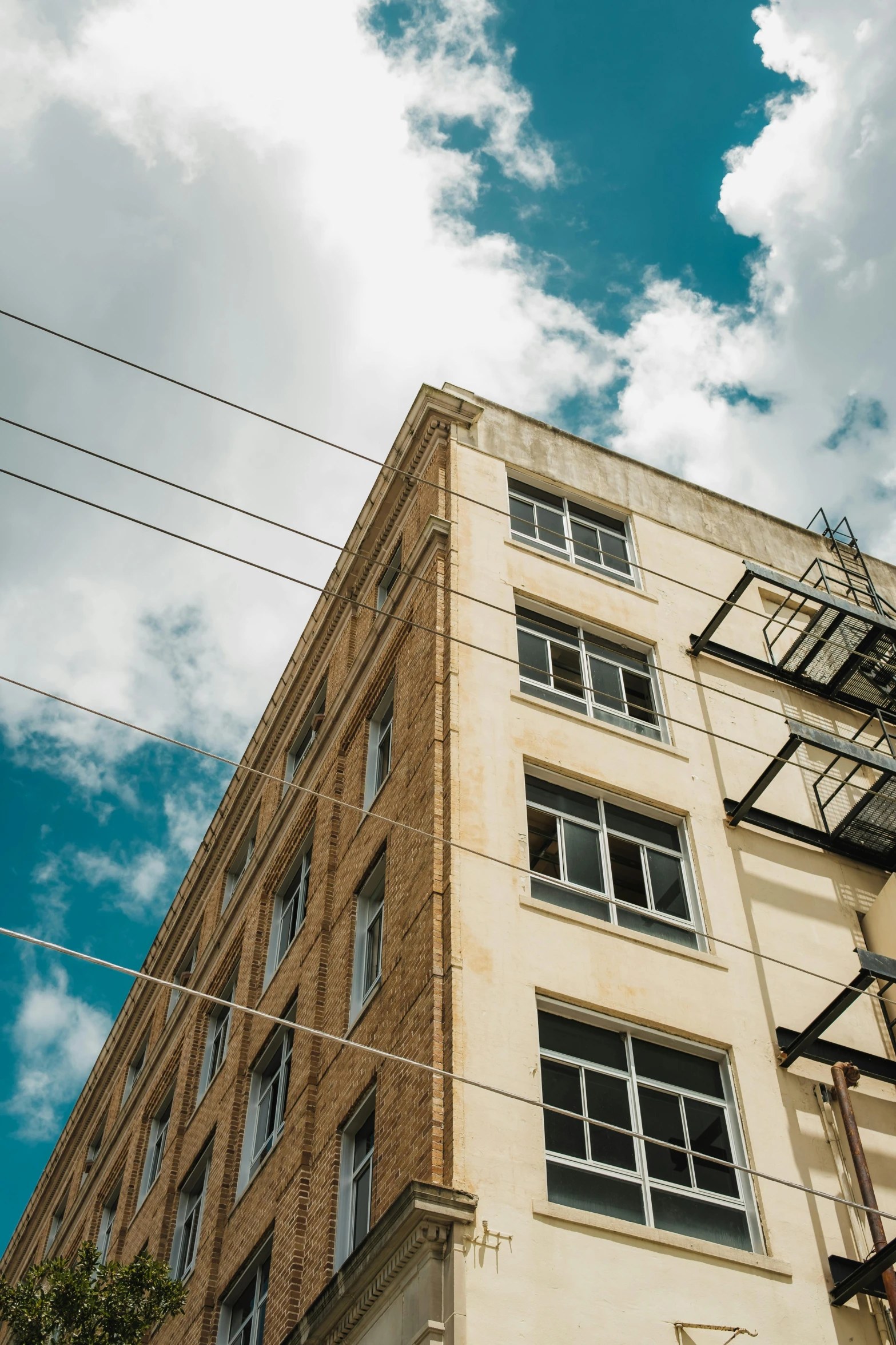 some wires are hanging from a building on the street