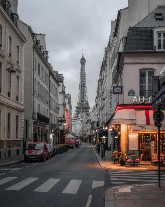 an empty city street with the eiffel tower towering in the background