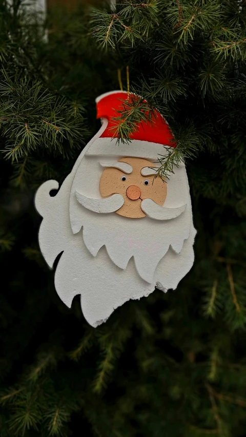 a close up of a paper santa claus decoration