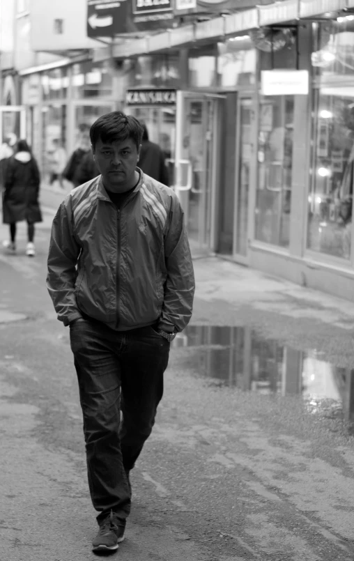 a man in an all black and white street walking