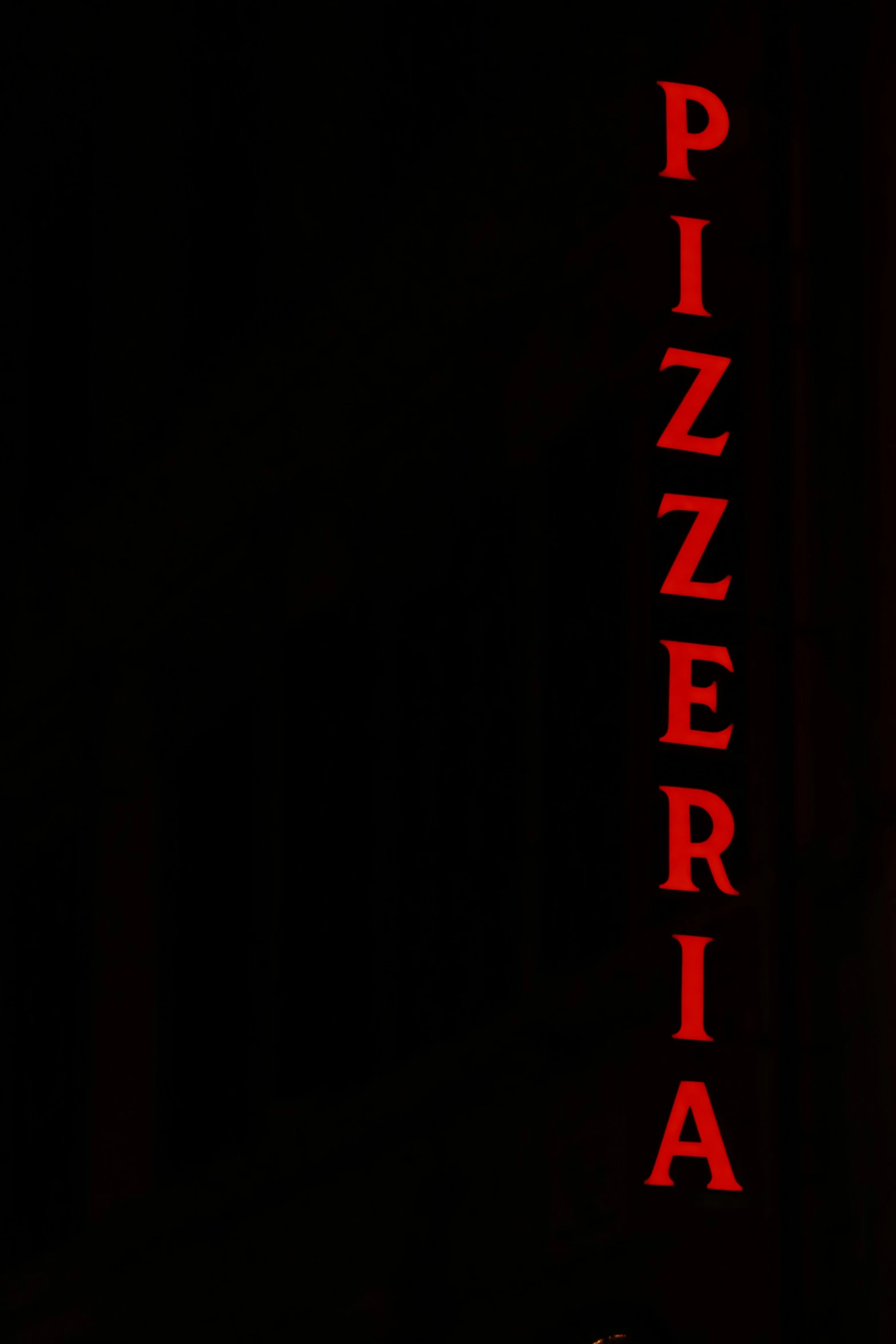 a dark red neon sign in front of the words pizzaeria