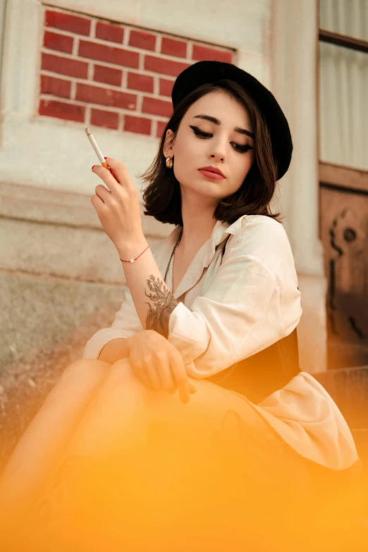 woman sitting on the steps smoking and looking at a cigarette