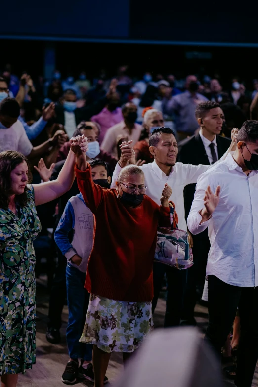 a crowd of people standing next to each other