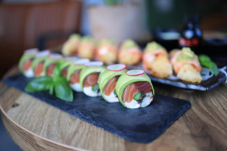 small rolls on trays next to some sliced avocado