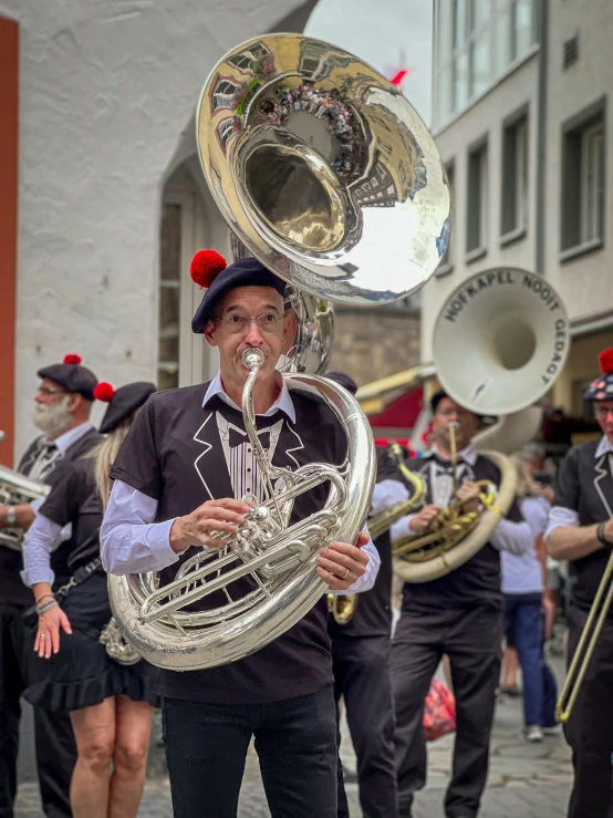 a person with a band and trombone on a street