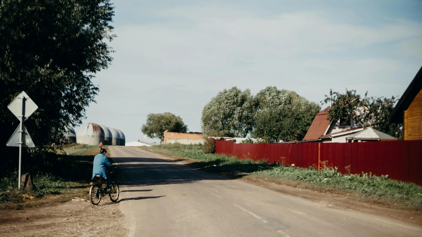 a young man riding a bike down a road