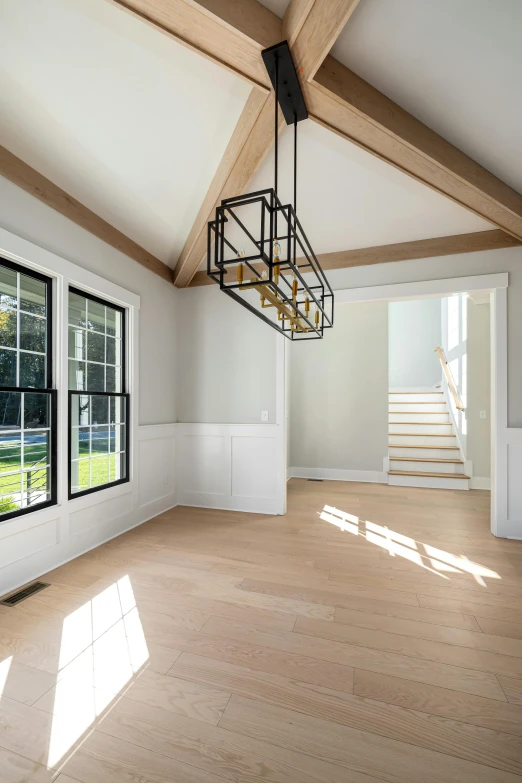 a large open floorplans with white walls and wood floors