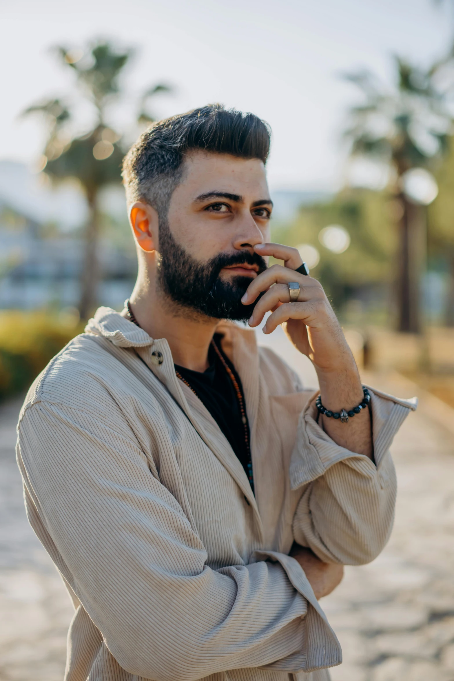 a bearded man is talking on the phone