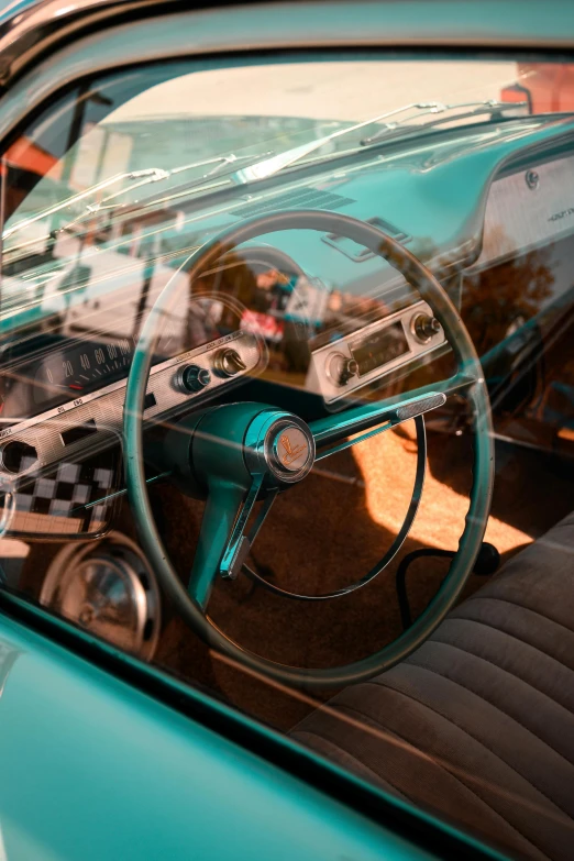 a car dashboard with a meter, steering wheel and the sunroof