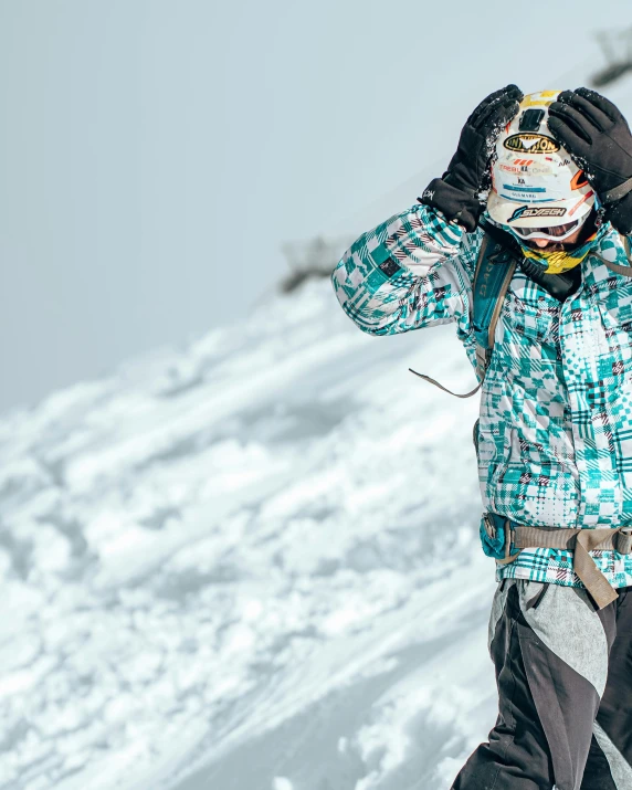 the man is skiing on the mountain with a snowboard